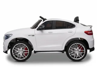 Mercedes GLC 63 AMG 12V blanc, profil latéral, jantes chromées AMG, fond blanc studio